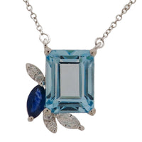 Sky Blue Topaz with Diamond & Blue Sapphire Leaf Pendant. 18K White Gold: 1.853 grams Diamond: 0.042 ct MQ: 0.062 ct Blue Sapphire: 0.22 ct Sky Blue Topaz: 3.41 ct Chain 