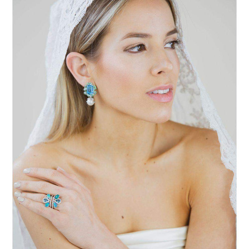 This pair of earrings are perfect for special occasions, this design gives the piece a feminine touch.  Swiss Blue Topaz, Tsavorite, Pearls & Diamond Earrings